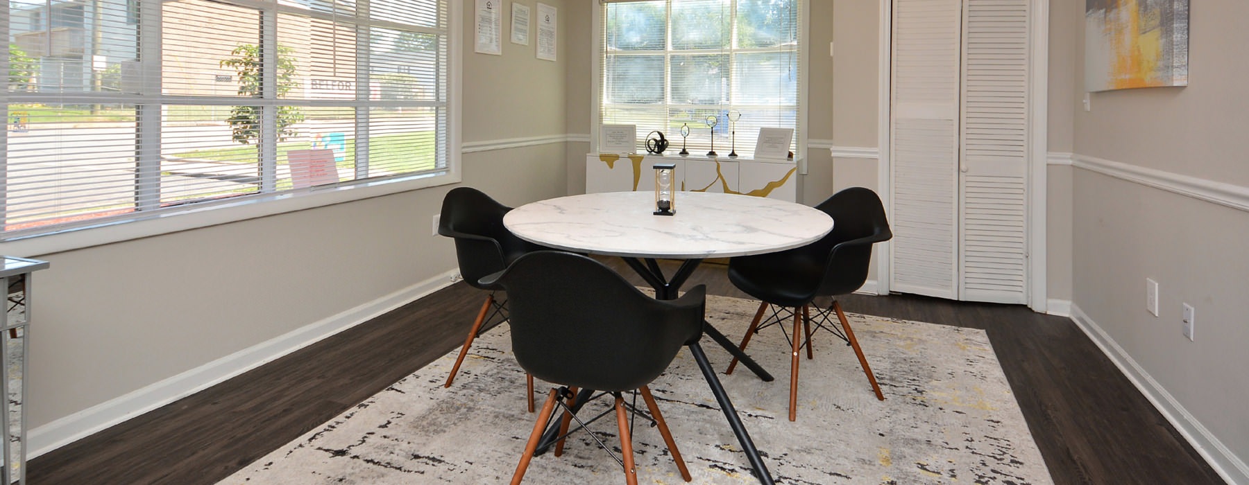 stylize lighting over table with chairs in leasing office
